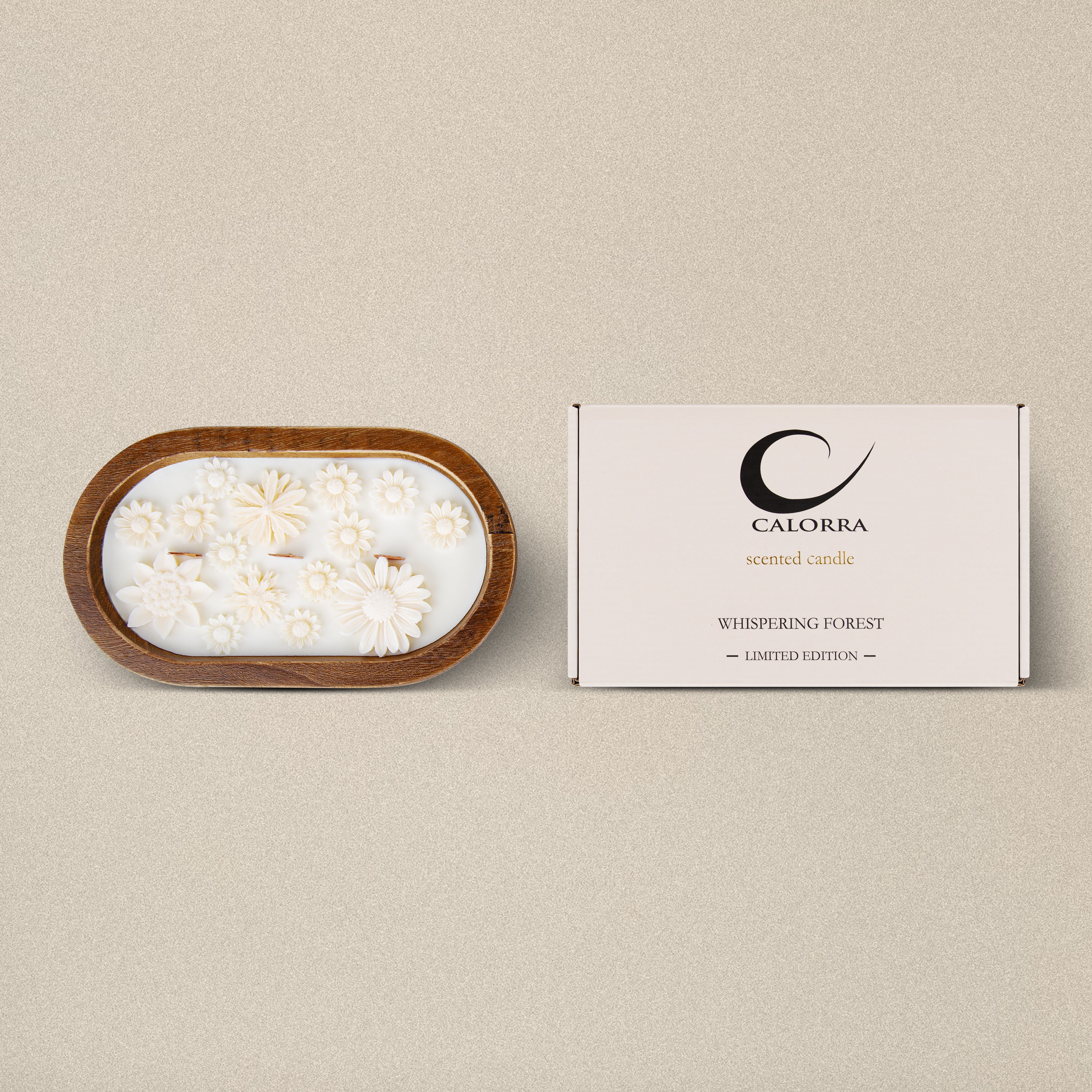 Luxury cedarwood scented candle Whispering Forest by Calorra in a handcrafted wooden jar with wax floral design and gift box on beige background